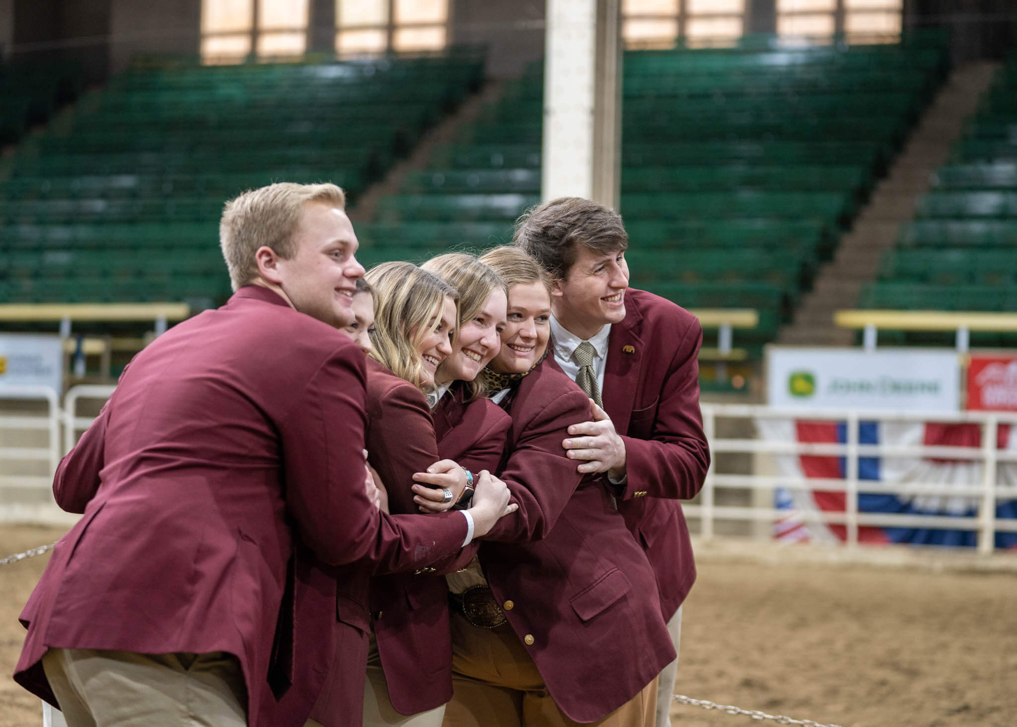 A group of people hugging in an arena.
