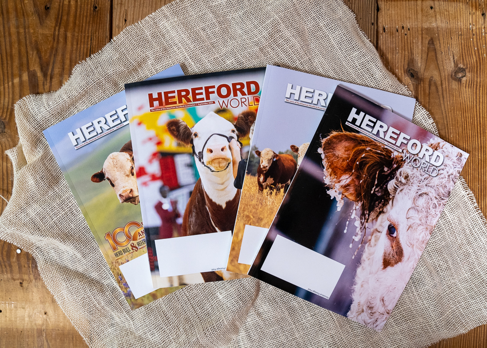 Hereford World magazine covers on a wooden table.